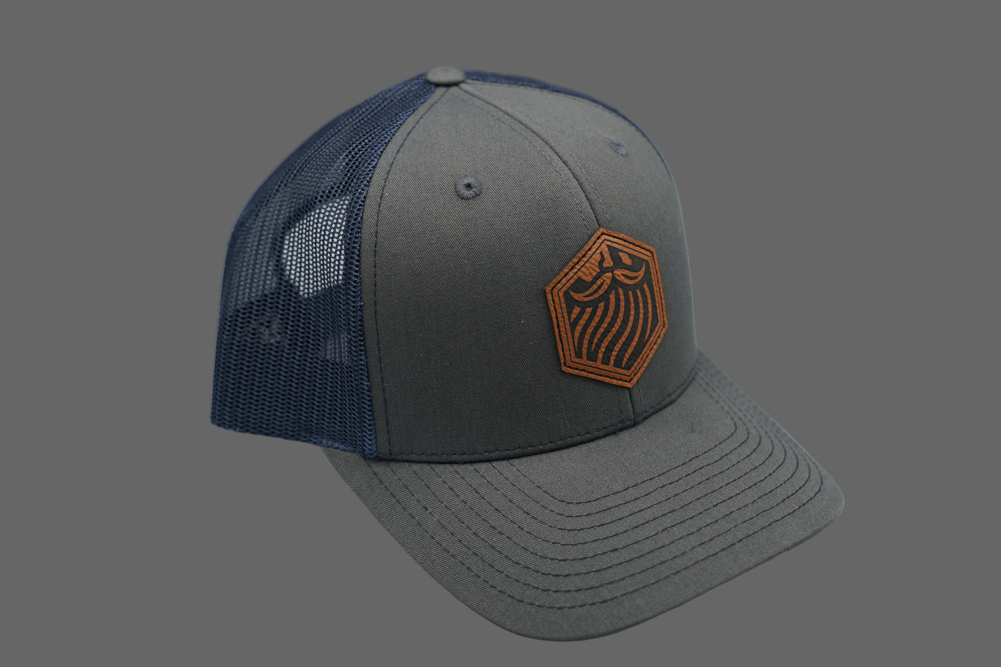Gray and blue cap with a logo on a gray background