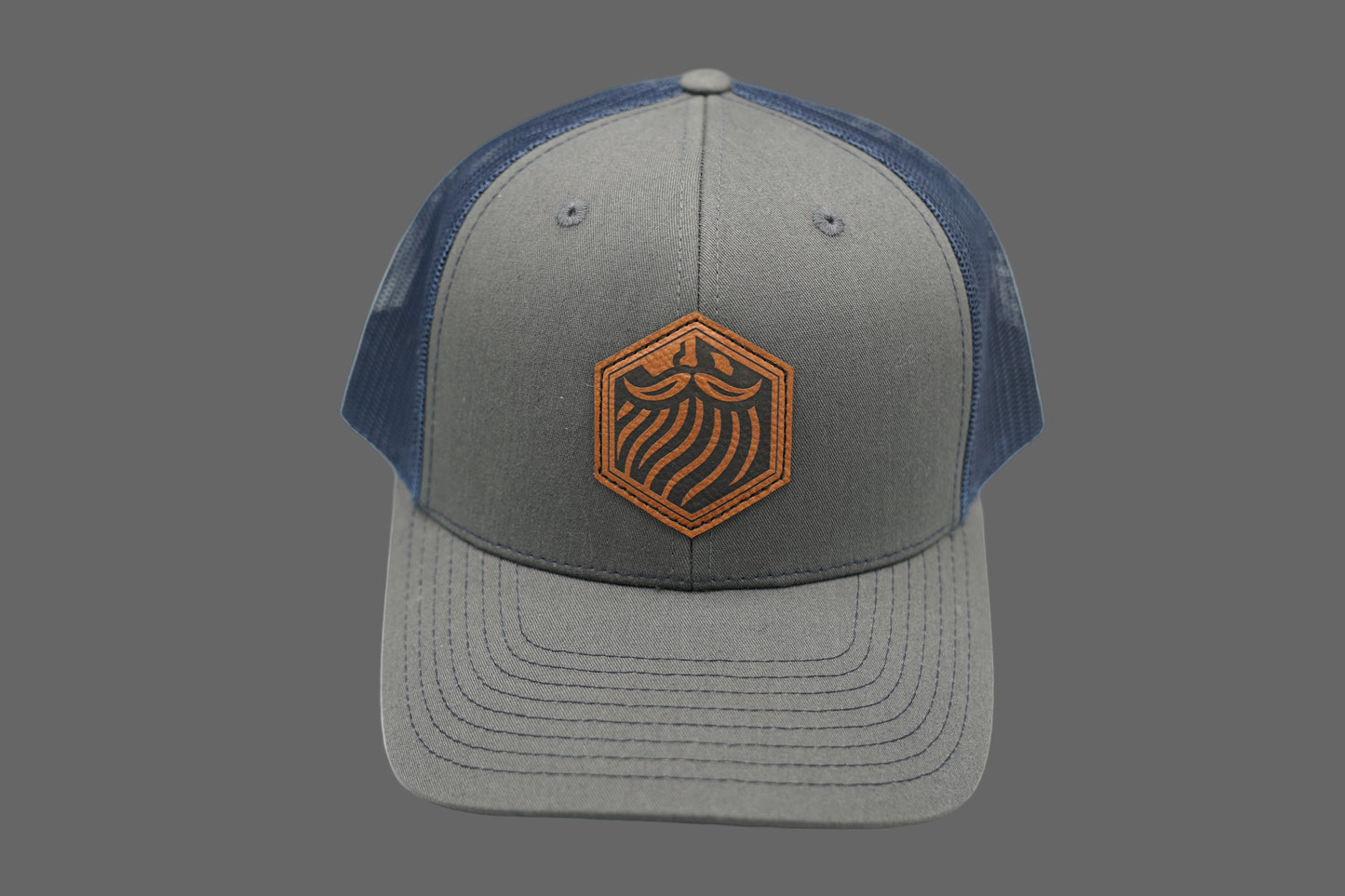 Gray and blue cap with a logo on a gray background
