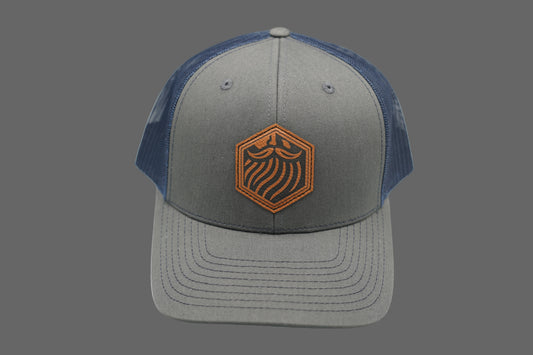 Gray and blue cap with a logo on a gray background