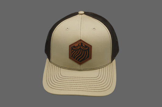 Beige and brown cap with a logo on a gray background