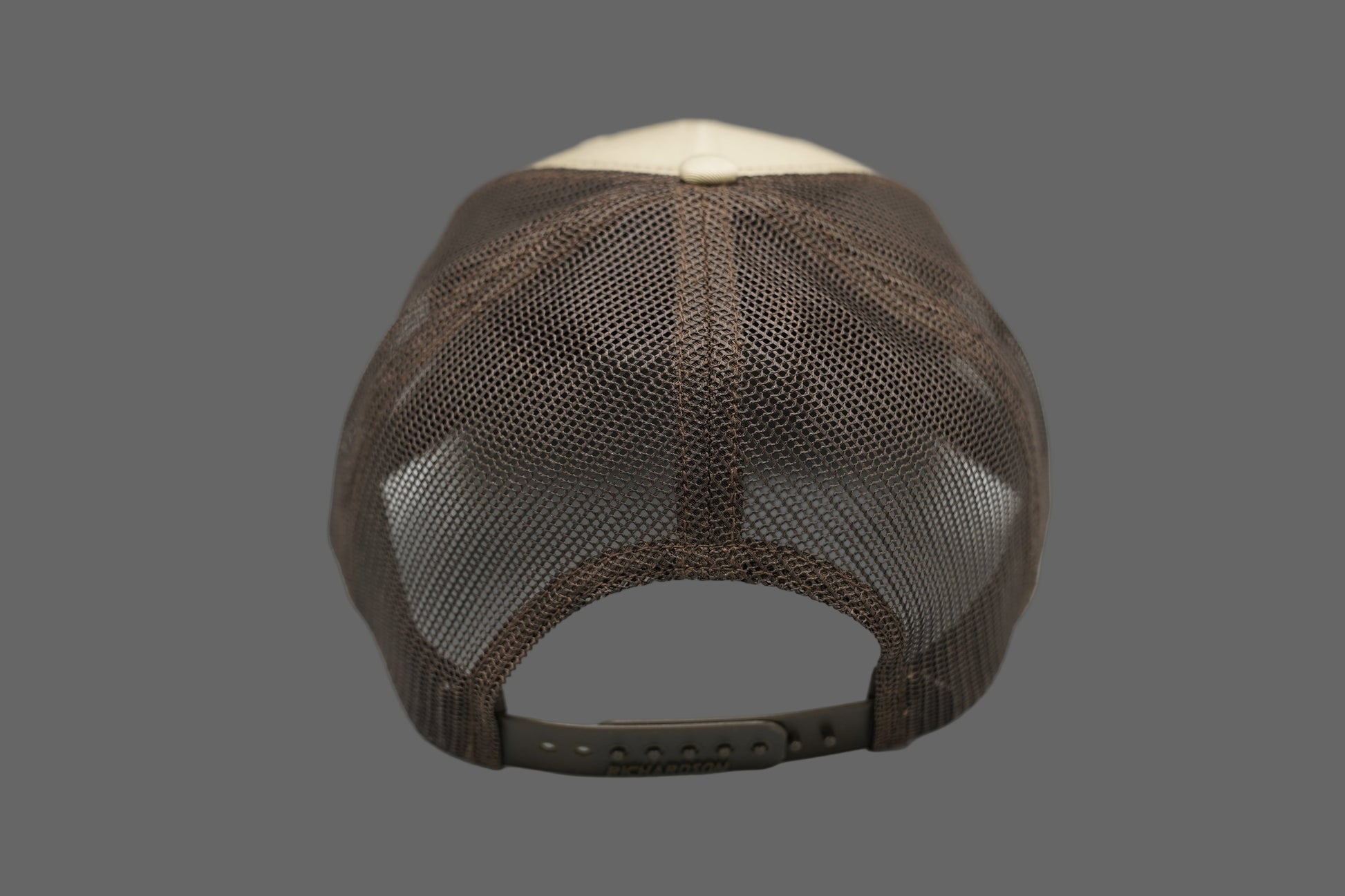 Beige and brown cap with a logo on a gray background