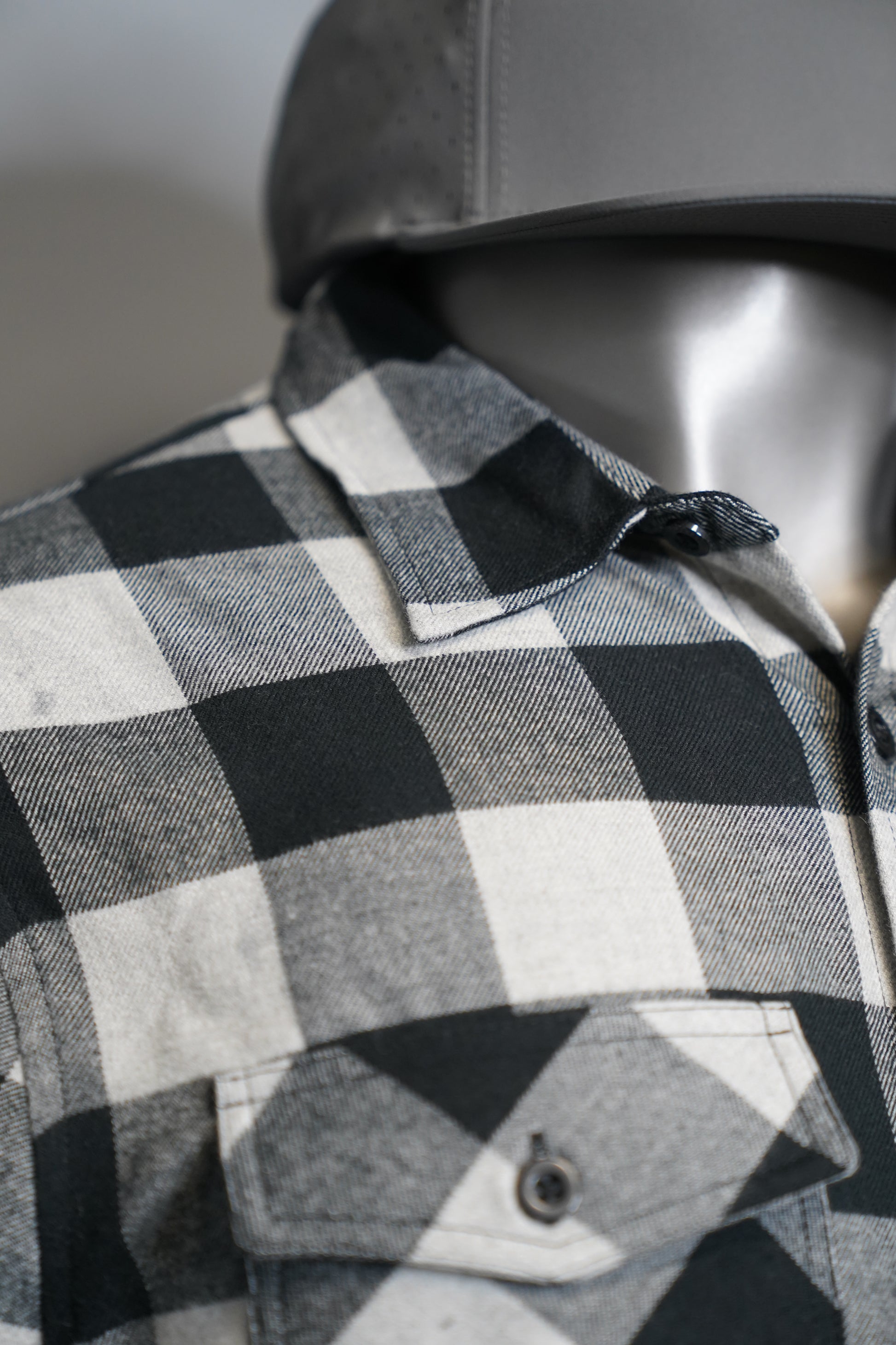 Close-up of a black and white checkered fabric with a blurred background
