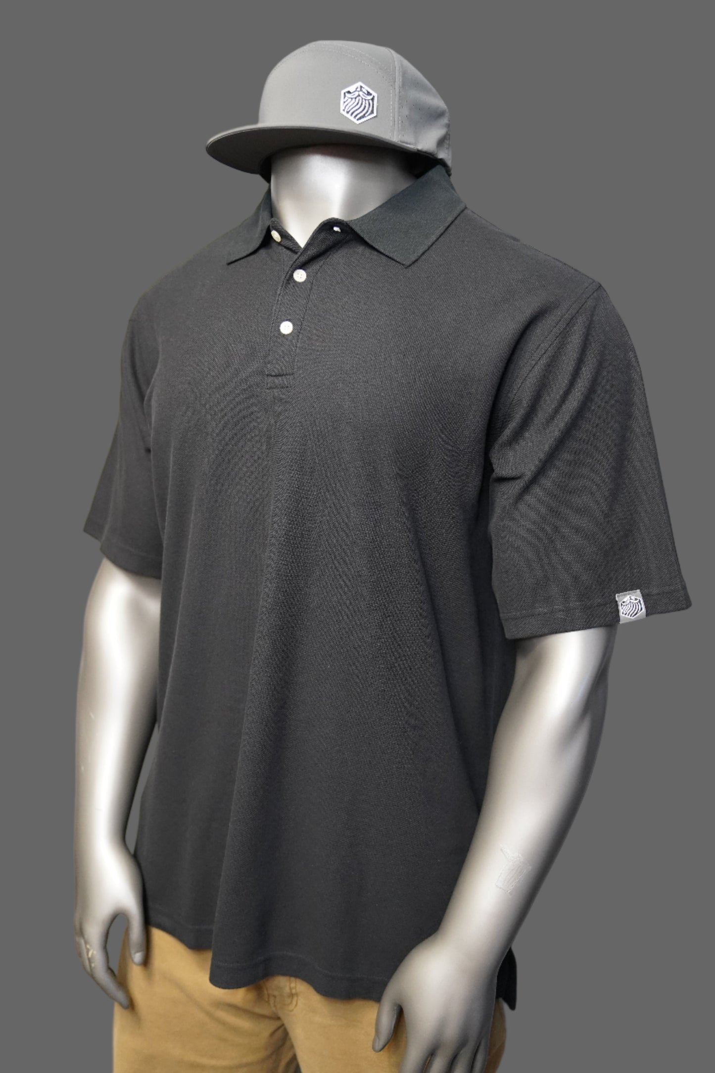 Black polo shirt against a gray background