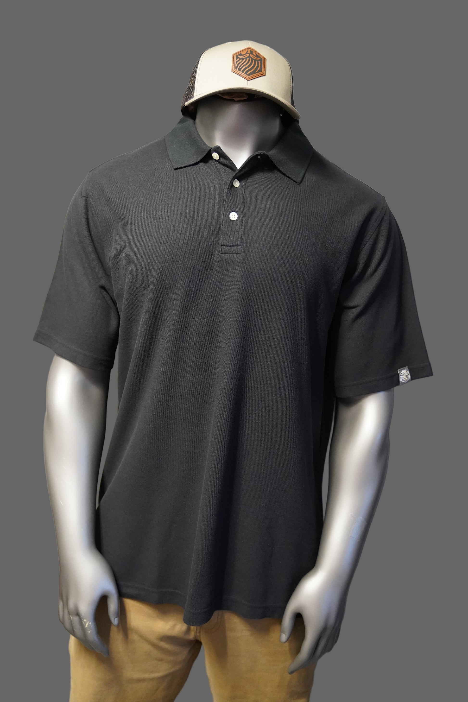 Black polo shirt against a gray background