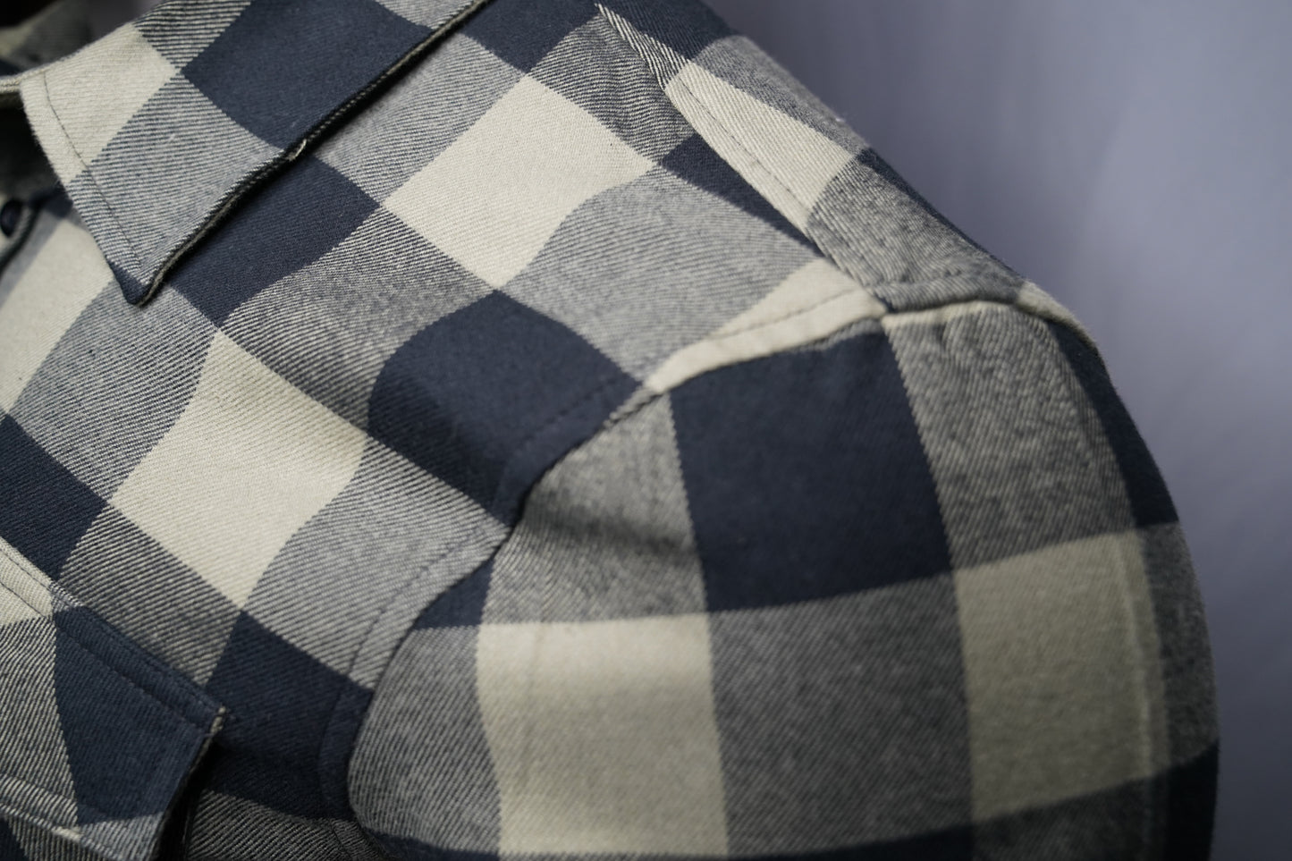 Close-up of black and olive checkered fabric texture