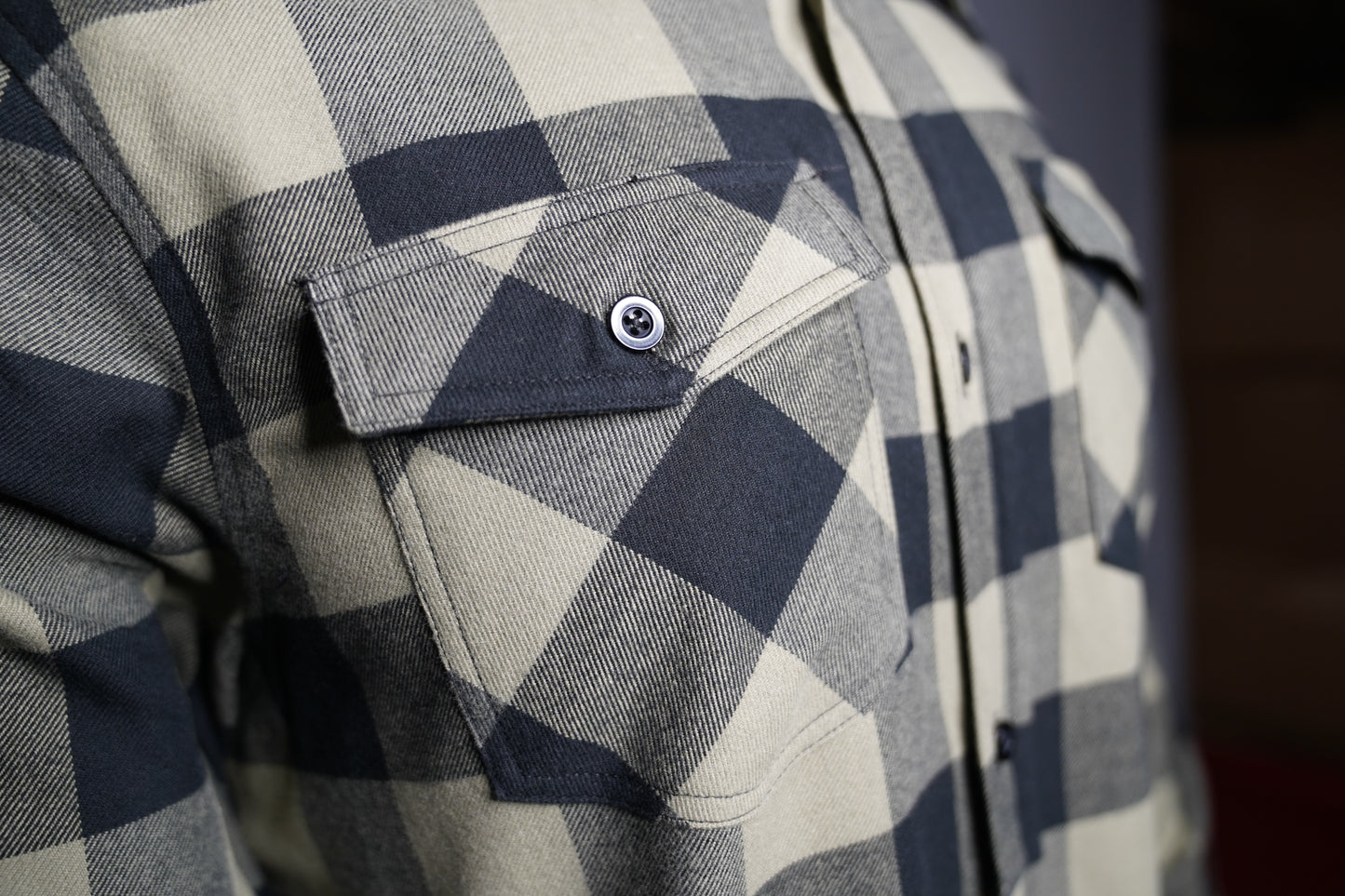 Close-up of black and olive checkered fabric texture chest pocket
