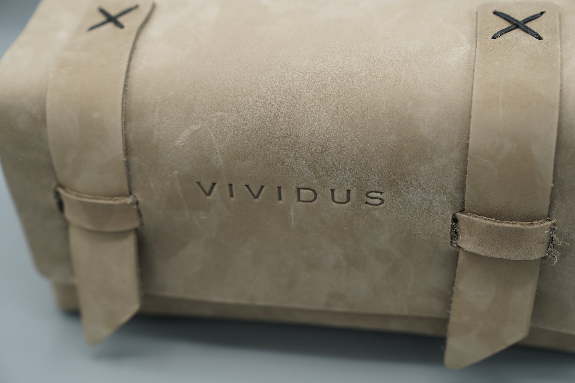 Leather Dopp Kit Bag roll-up bag with 'VIVIDUS' branding on a gray background