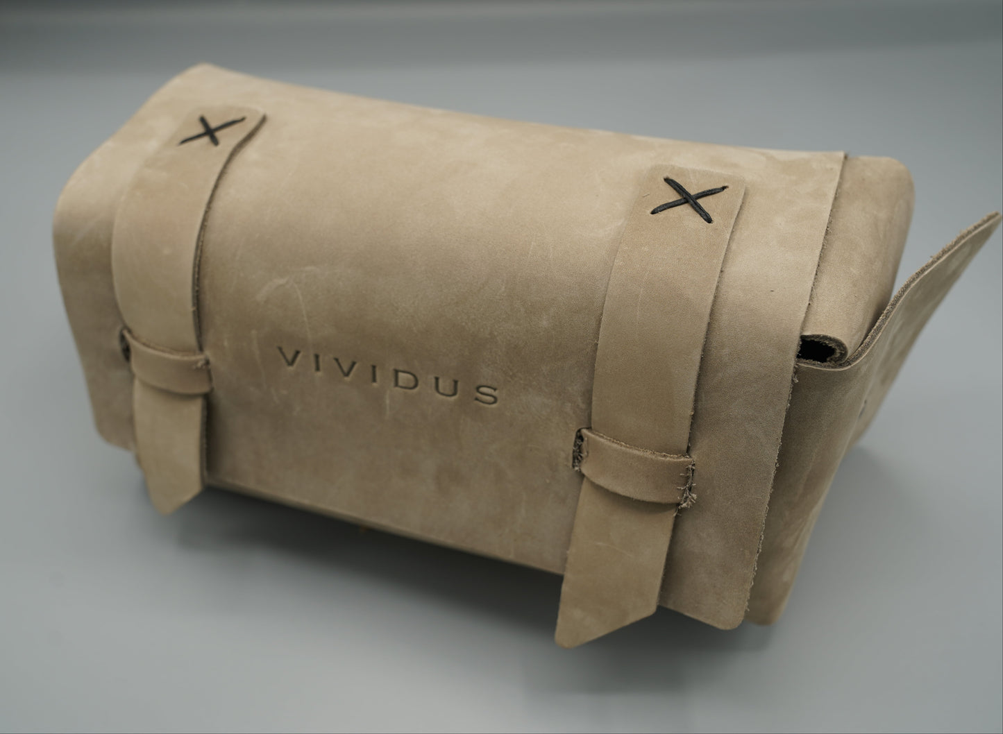 Leather Dopp Kit Bag roll-up bag with 'VIVIDUS' branding on a gray background