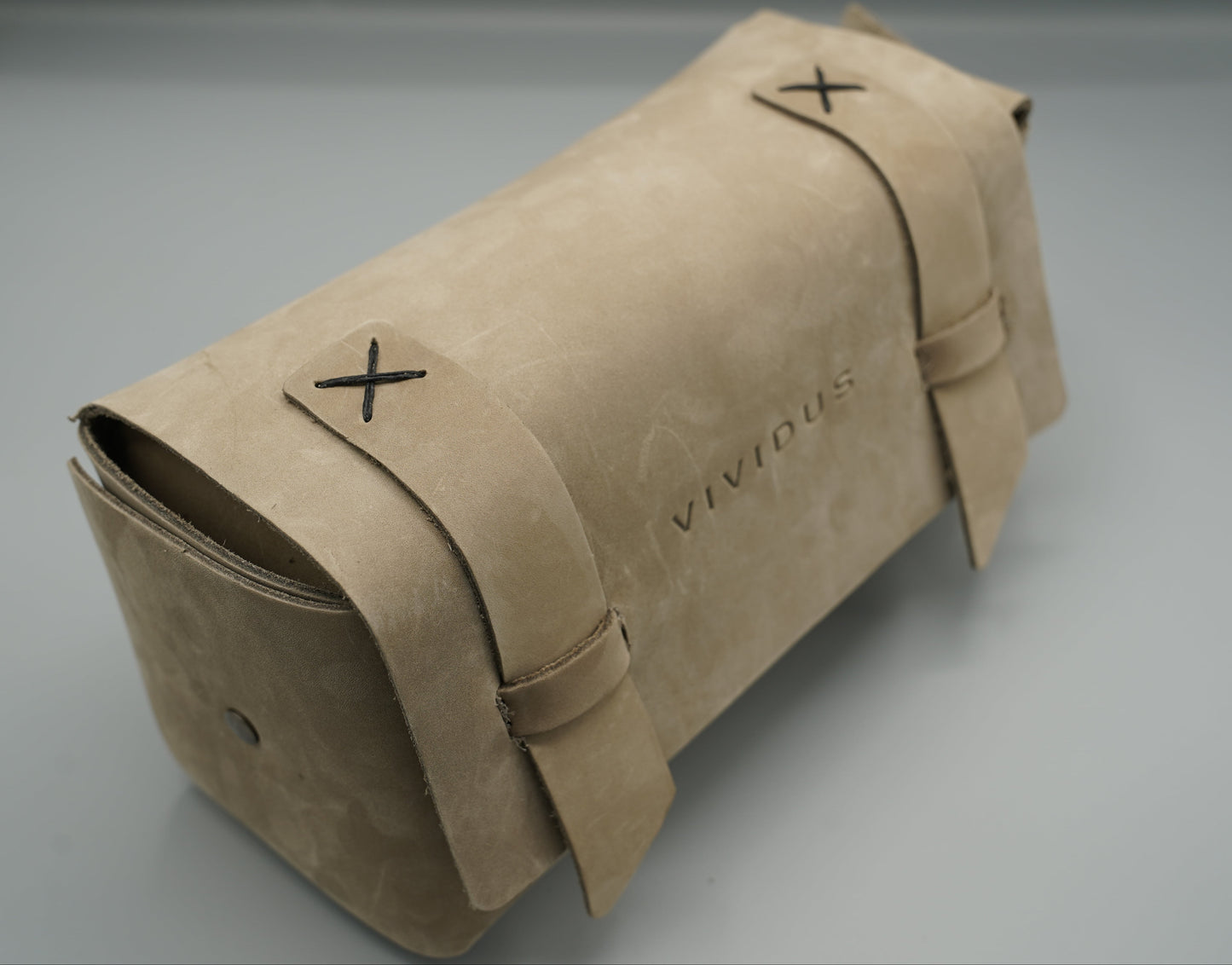 Leather Dopp Kit Bag roll-up bag with 'VIVIDUS' branding on a gray background