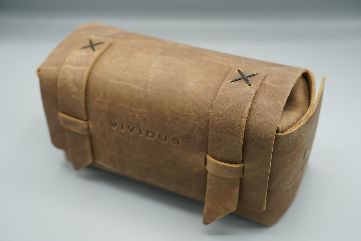 Distressed broen Leather Dopp Kit Bag roll-up bag with 'VIVIDUS' branding on a gray background