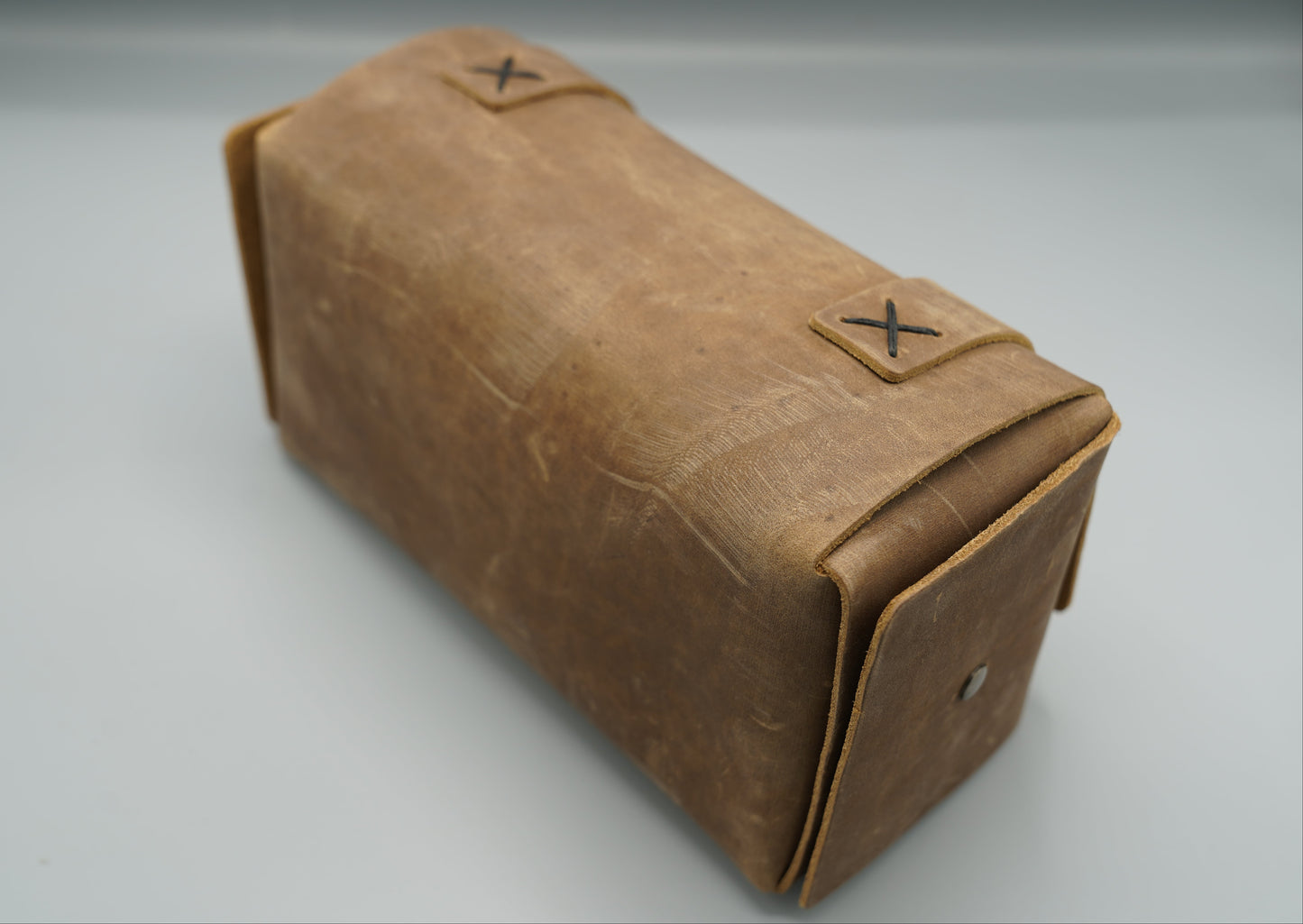 Distressed broen Leather Dopp Kit Bag roll-up bag with 'VIVIDUS' branding on a gray background
