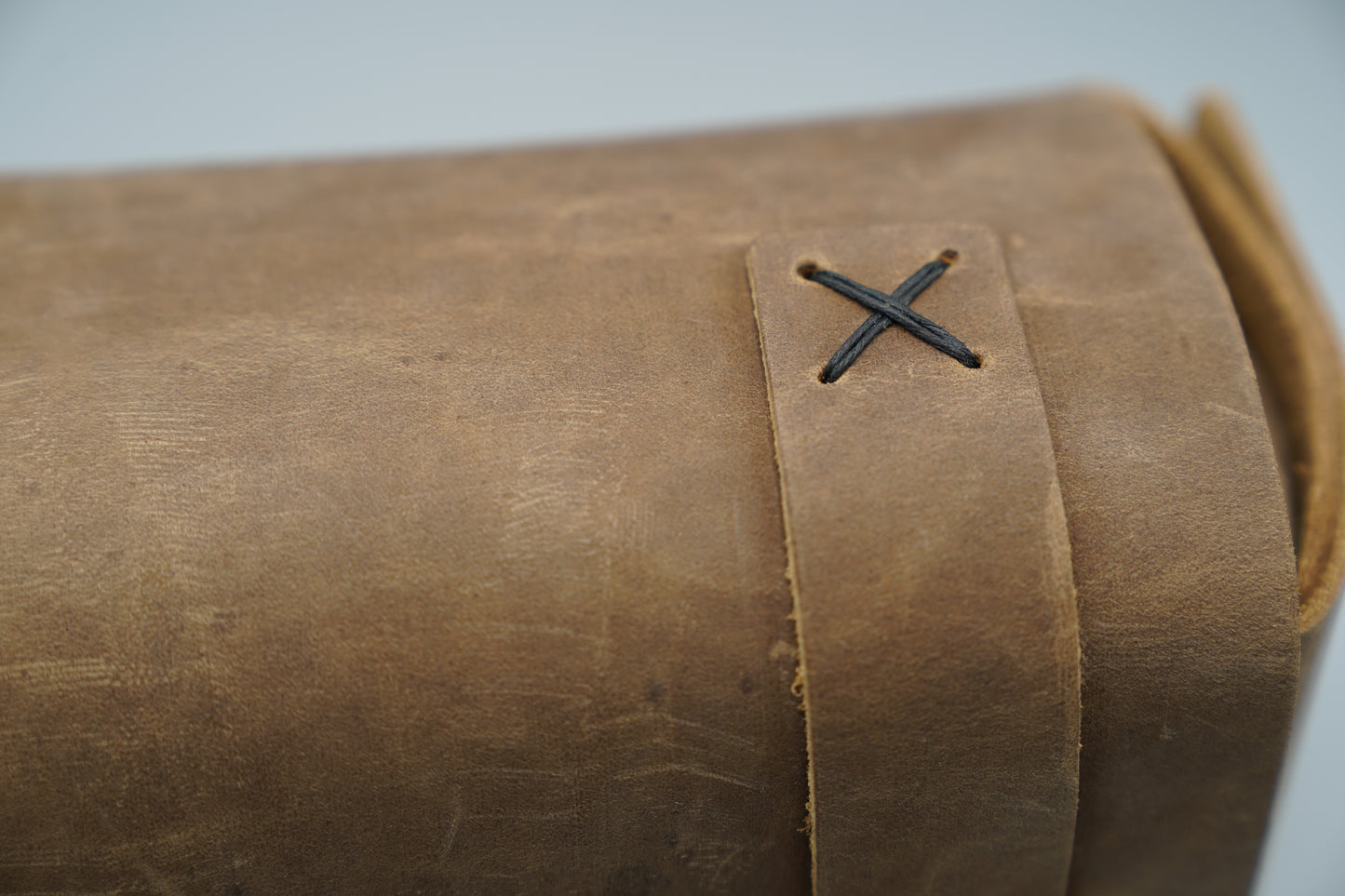 Distressed broen Leather Dopp Kit Bag roll-up bag with 'VIVIDUS' branding on a gray background