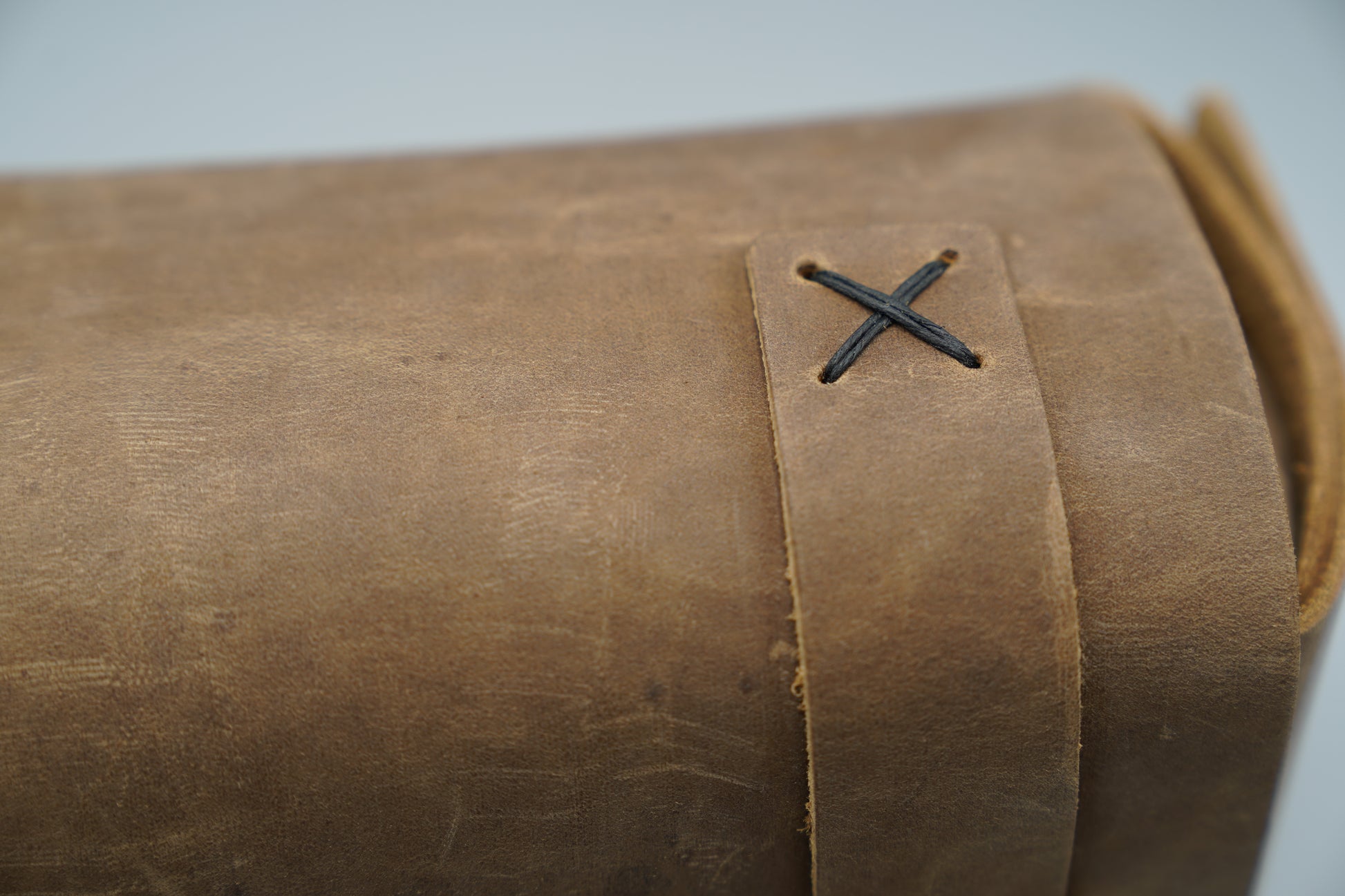 Distressed broen Leather Dopp Kit Bag roll-up bag with 'VIVIDUS' branding on a gray background