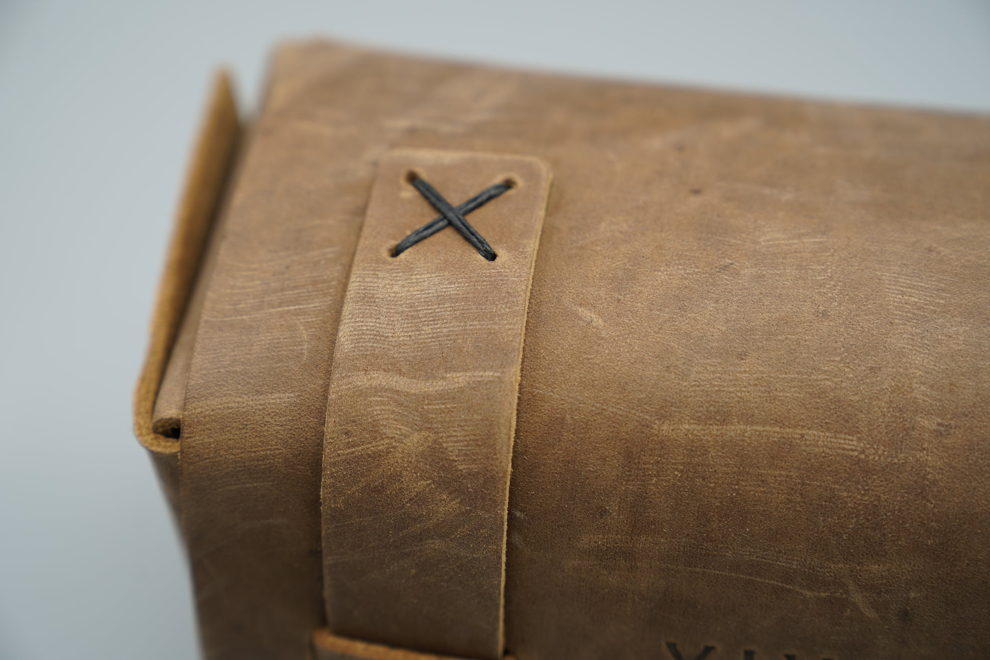 Distressed broen Leather Dopp Kit Bag roll-up bag with 'VIVIDUS' branding on a gray background